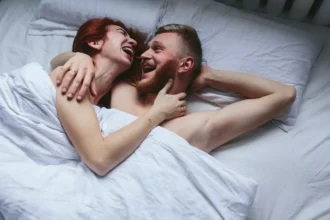 couple laughing bed 6841f646084ee