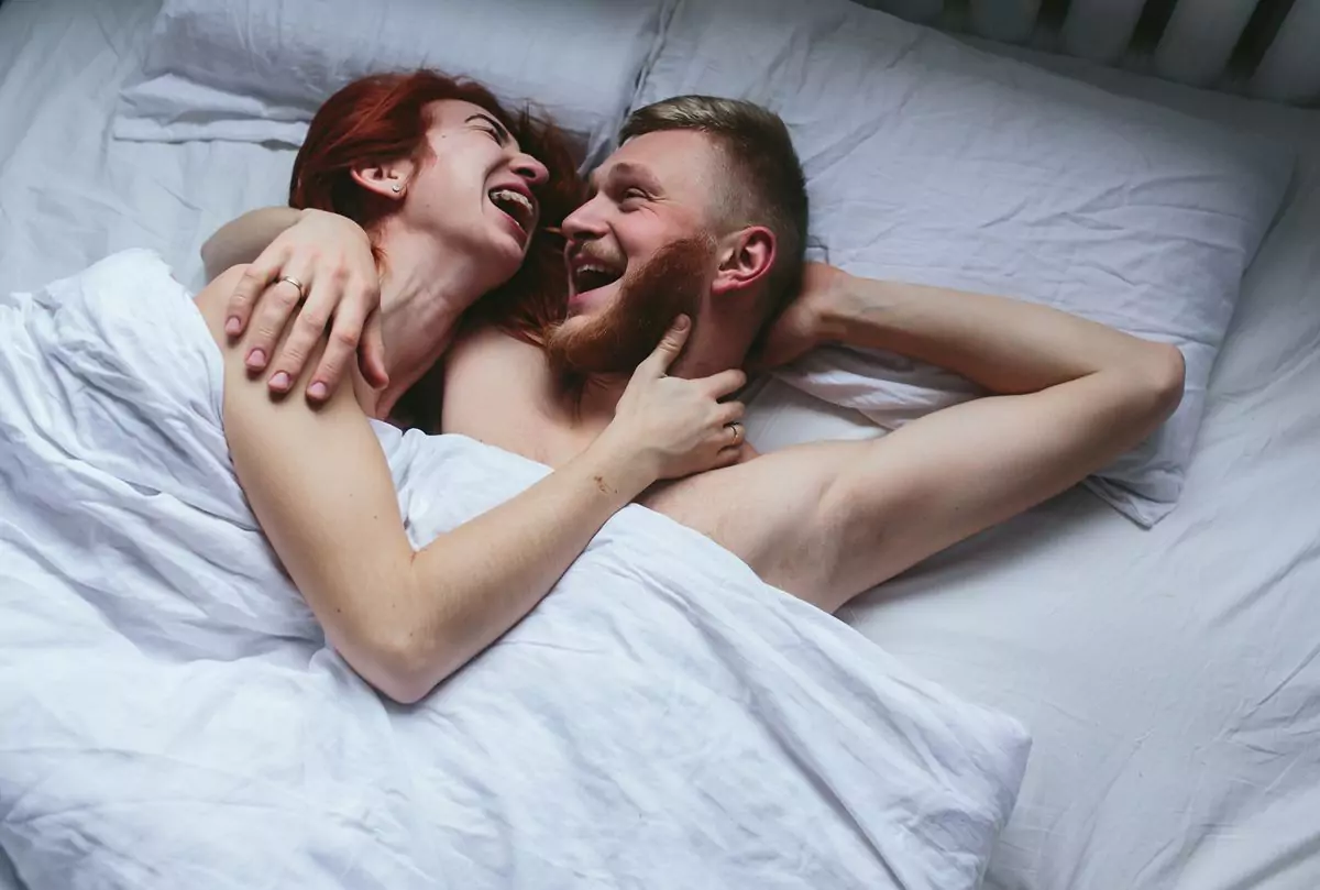 couple laughing bed 6841f646084ee