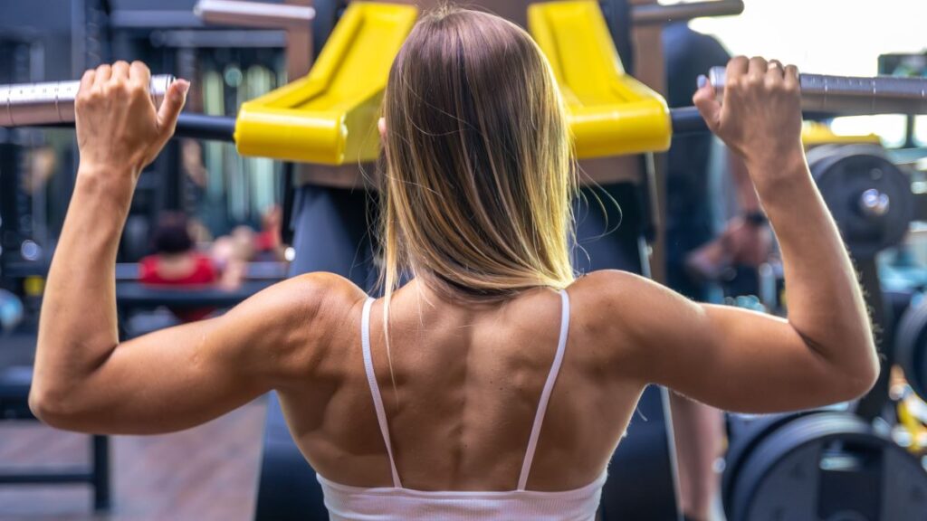 girl swings her back exercise machine
