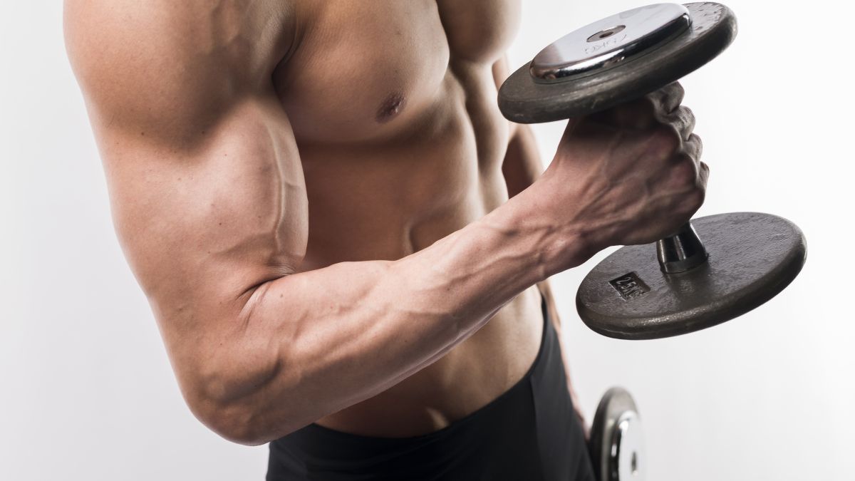 side view athletic man torso holding weights