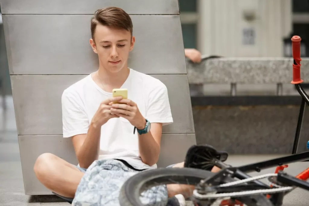 teenage boy wearing white t shirt using smartphone 69848146ad018