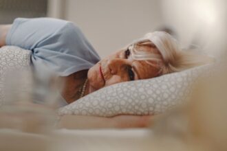 pensive senior woman lying bed thinking something
