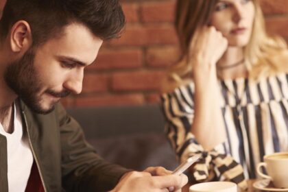man using cell phone meeting with girlfriend