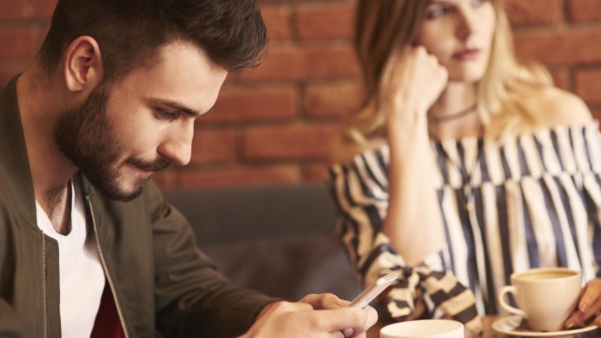 man using cell phone meeting with girlfriend