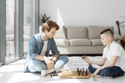 tutor learning boy how play chess long view