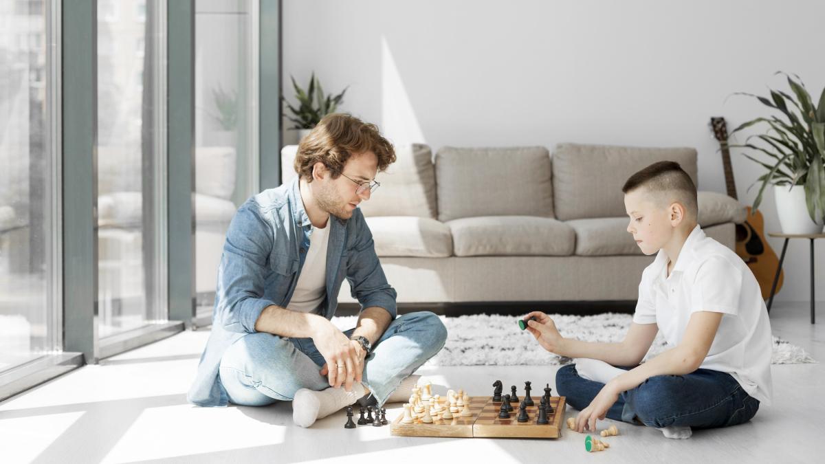 tutor learning boy how play chess long view
