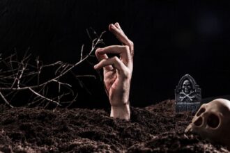 hand sticking out ground near skull