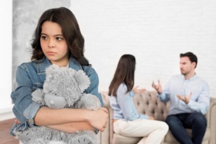 portrait sad child holding her teddy bear