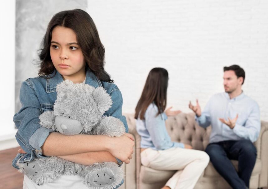portrait sad child holding her teddy bear